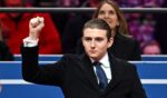 Barron Trump gestures after being acknowledged by his father, President Donald Trump, during the inaugural parade inside Capital One Arena, in Washington, D.C., on Jan. 20, 2025.