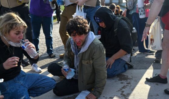 Demonstrators protesting outside a U.S Immigration and Customs Enforcement facility, including Democratic congressional candidate Kat Abughazaleh, left, react after being tear-gassed on Sept. 19, 2025, in Broadview, Illinois.