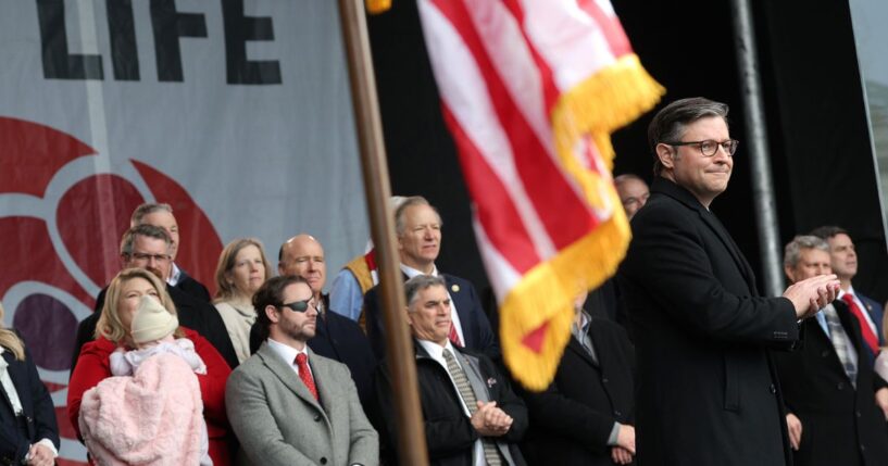Speaker of the House Mike Johnson applauds on stage alongside fellow Republican lawmakers during the annual March for Life rally on the National Mall on Jan. 23, 2026, in Washington, D.C.