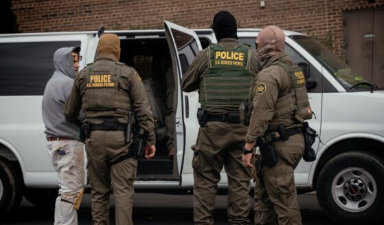 People detained earlier in the day are taken to a parking lot on the far north side of the city before being transferred to an Immigration and Customs Enforcement facility on Oct. 31, 2025, in Chicago, Illinois.