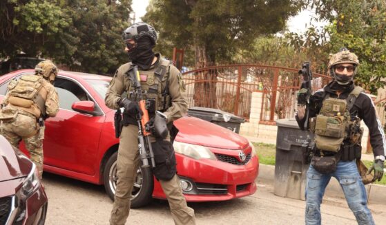 Border Patrol agents and other law enforcement ask a car to make room for a police vehicle to pass while investigating a shooting involving a federal agent on Wednesday morning in Willowbrook on Jan. 21, 2026.