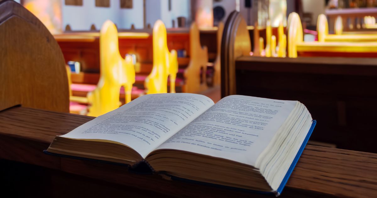 Open Bible is seen in a stock photo on a church pew.