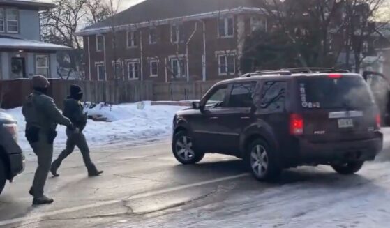 The officers are seen approaching the vehicle to confront the driver.