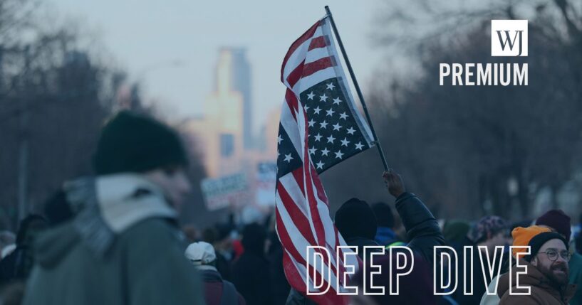 A demonstrator holds an upside down American flag during a vigil following Wednesday's shooting by an ICE agent during federal law enforcement operations in Minneapolis, Minnesota.
