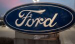A sign with the Ford logo sits in front of a Chicago dealership in a file photo dated Dec. 15.