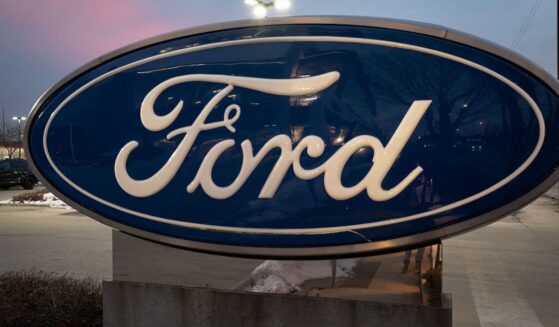 A sign with the Ford logo sits in front of a Chicago dealership in a file photo dated Dec. 15.