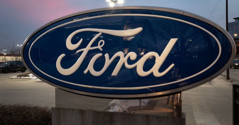 A sign with the Ford logo sits in front of a Chicago dealership in a file photo dated Dec. 15.