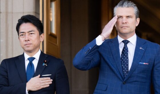 Defense Secretary Pete Hegseth and Japanese Defense Minister Shinjiro Koizumi, left, stand for the national anthems Thursday as Koizumi arrives for meetings at the Pentagon in Washington, D.C.
