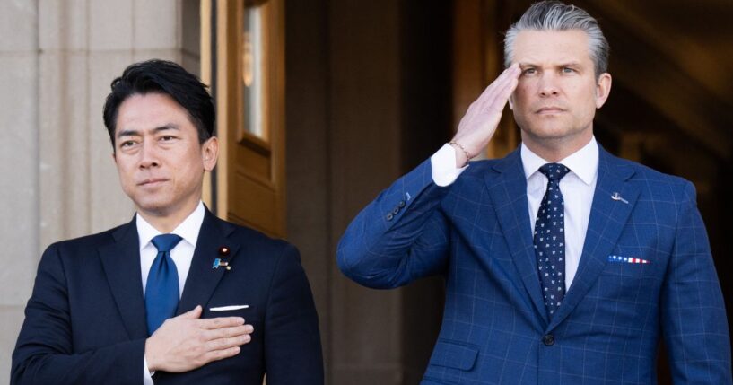 Defense Secretary Pete Hegseth and Japanese Defense Minister Shinjiro Koizumi, left, stand for the national anthems Thursday as Koizumi arrives for meetings at the Pentagon in Washington, D.C.