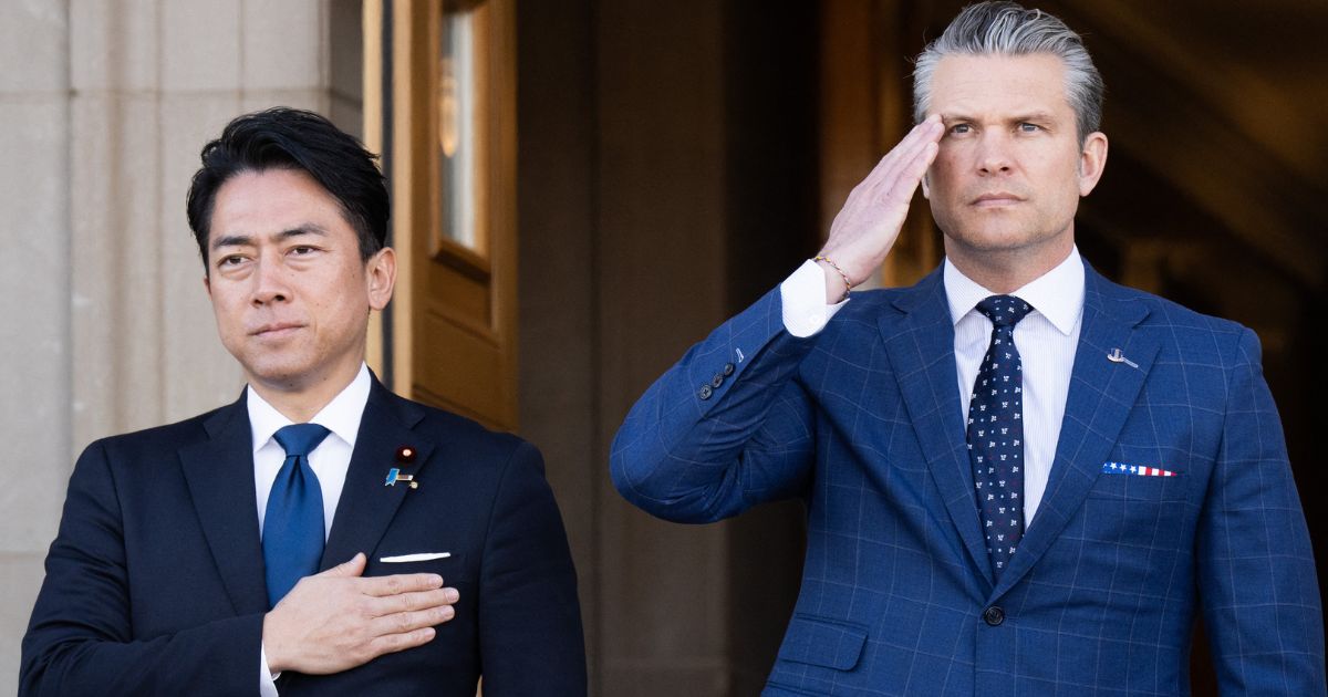 Defense Secretary Pete Hegseth and Japanese Defense Minister Shinjiro Koizumi, left, stand for the national anthems Thursday as Koizumi arrives for meetings at the Pentagon in Washington, D.C.