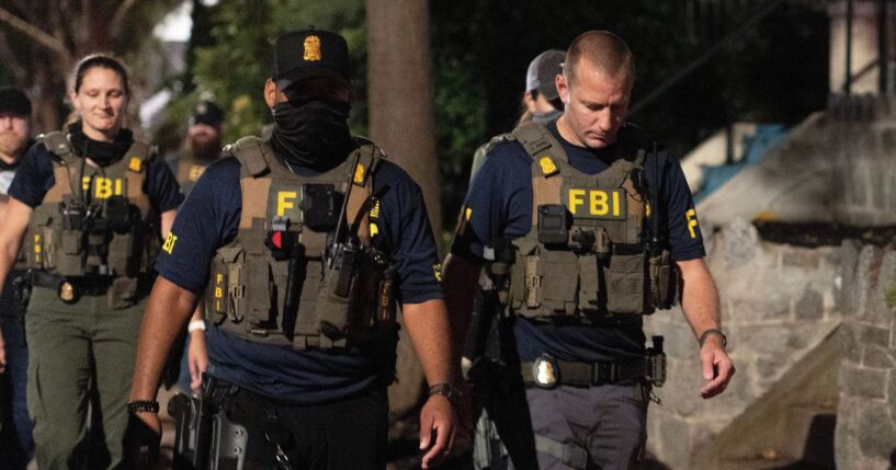 FBI agents walk down Florida Avenue on Aug. 13, 2025 as part of President Donald Trump's deployment of federal officers and the National Guard in Washington, DC.