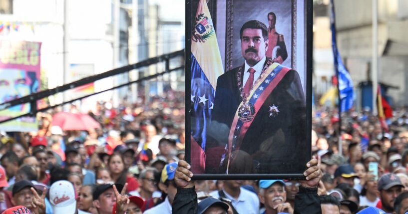 Supporters of ousted Venezuelan President Nicolas Maduro carry his portrait in a rally in Caracas on Jan. 5, 2026.