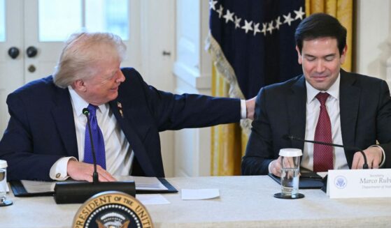 President Donald Trump speaks with Secretary of State Marco Rubio during a meeting with American oil executives in the East Room of the White House in Washington, DC on Jan. 9, 2026.