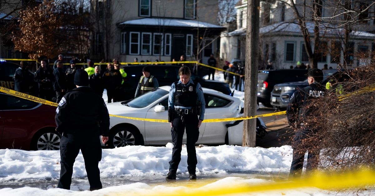 Minneapolis Police officers stand at the scene of a shooting where a law enforcement officer "fearing for his life" shot and killed a woman who actively impeded an ICE operation, refused to follow lawful orders, and then drove straight at said officer in Minneapolis, Minnesota, on Jan. 7, 2026.