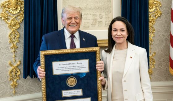 President Donald Trump accepts a Nobel Peace Prize originally awarded to Venezuelan opposition leader Maria Corina Machado who chose to gift it to him in the Oval Office of the White House on Jan. 15, 2026 in Washington, DC.