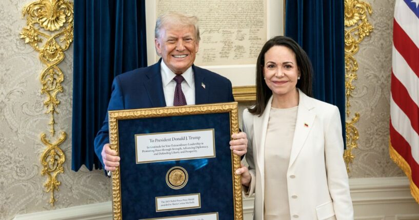 President Donald Trump accepts a Nobel Peace Prize originally awarded to Venezuelan opposition leader Maria Corina Machado who chose to gift it to him in the Oval Office of the White House on Jan. 15, 2026 in Washington, DC.