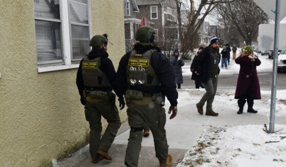 Federal agents patrol a neighborhood in St. Paul, Minnesota, on Jan. 16, 2026.