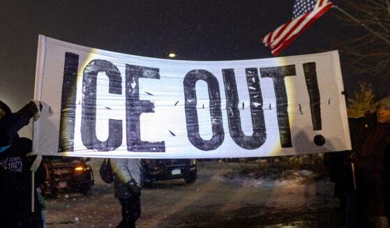 Protesters hold a large anti-ICE sign in Minneapolis, Minnesota on Jan. 18, 2026.