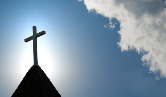 An old wood cross on a church steeple.