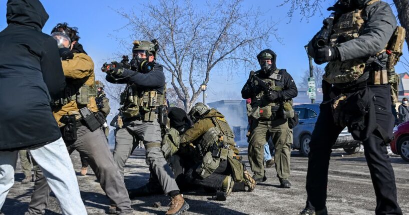 A person is tackled by federal agents as unrest escalates in Minneapolis, Minnesota, on Jan. 24, 2026.