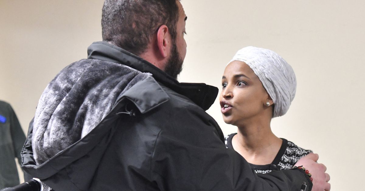 US Rep. Ilhan Omar reacts after being sprayed with an unknown substance by a man at a town hall in Minneapolis, Minnesota, on Jan. 27, 2026.
