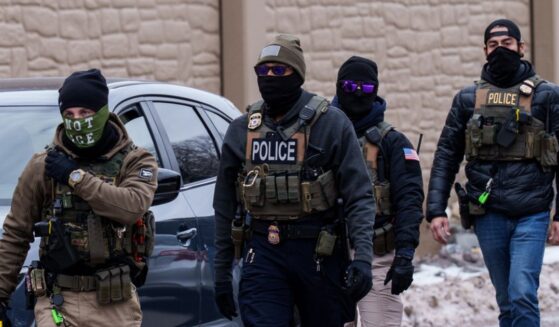 Immigration and Customs Enforcement agents walk near vehicles in Richfield, Minnesota, on Jan. 15, 2026.