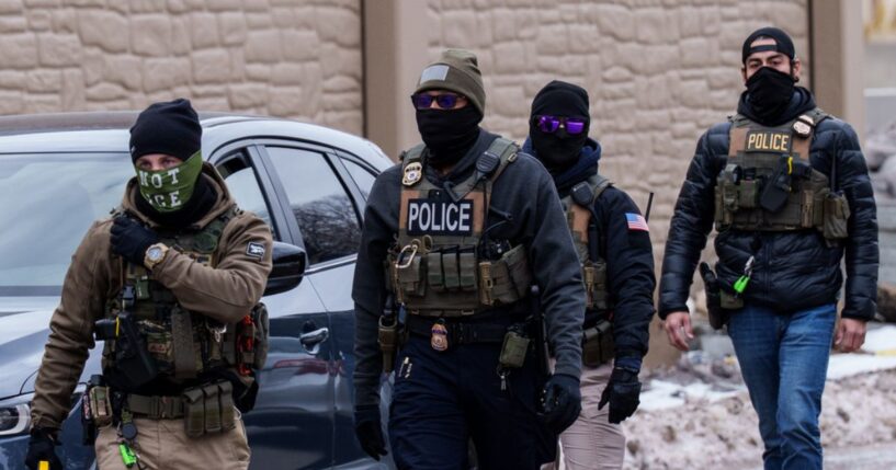Immigration and Customs Enforcement agents walk near vehicles in Richfield, Minnesota, on Jan. 15, 2026.