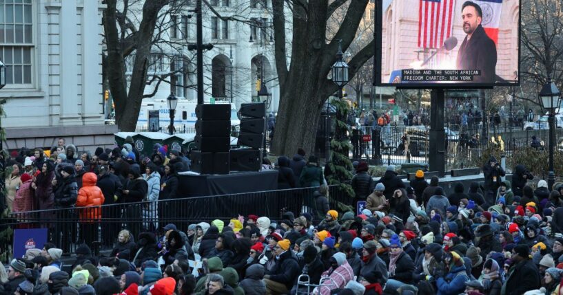 New York mayor Zohran Mamdani is seen on a screen as he speaks during his public inauguration ceremony followed by a block party at City Hall in New York on January 1, 2026.