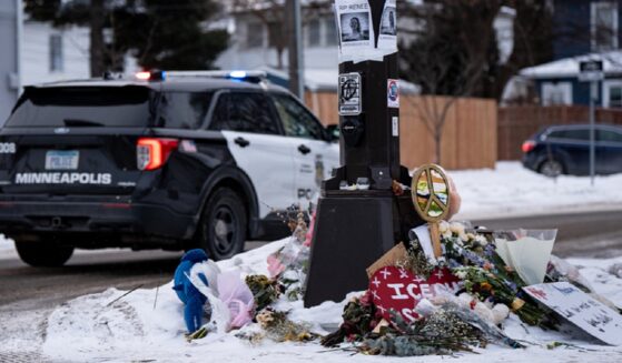 A Minneapolis police vehicle is parked near a memorial for anti-ICE protester Renee Good who was shot to death Jan. 7 while confronting Immigration and Customs Enforcement behind the wheel of her vehicle.
