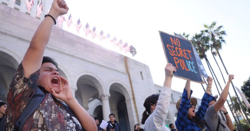 Teacher Andre Lopez, left, from Duarte Elementary School, joins activists and protesters take part in an