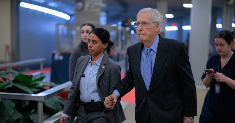 Sen. Mitch McConnell is assisted by U.S. Capitol Police as he heads for a vote on Jan. 14, 2026, in Washington, D.C.