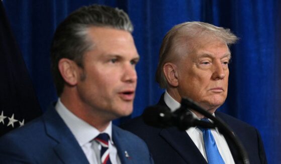 President Donald Trump looks on as Secretary of War Pete Hegseth speaks to the press following military actions in Venezuela, at Trump's Mar-a-Lago residence in Palm Beach, Florida, on Jan. 3, 2026.