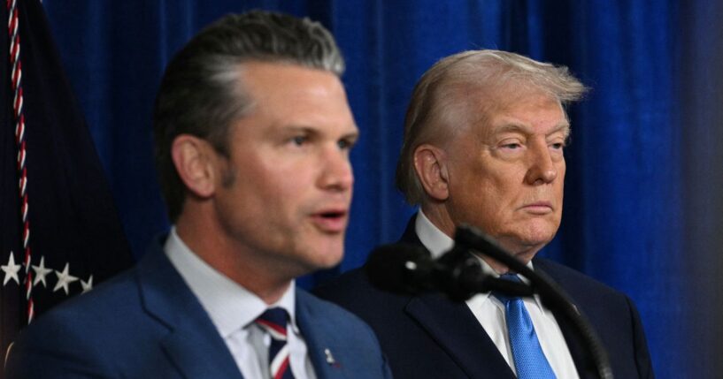 President Donald Trump looks on as Secretary of War Pete Hegseth speaks to the press following military actions in Venezuela, at Trump's Mar-a-Lago residence in Palm Beach, Florida, on Jan. 3, 2026.