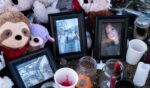 Candles, flowers, photographs, plush toys, and other items at a makeshift memorial for the victims four days after a deadly mass shooting took place at a school, in the town of Tumbler Ridge, British Columbia, Canada, on Feb. 13, 2026.