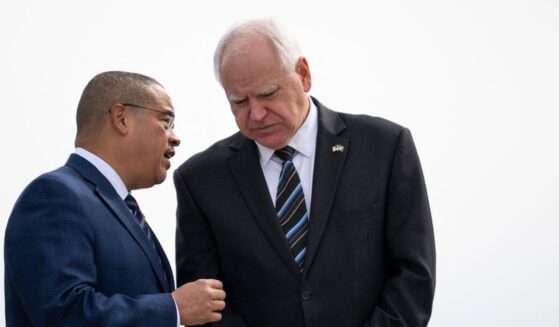 Minnesota Attorney General Keith Ellison and Minnesota Governor Tim Walz await the arrival of Vice President Kamala Harris at the Minneapolis-St. Paul International Airport in Saint Paul, Minnesota, on March 14, 2024.