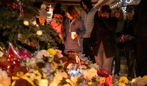 Community members mourn Wednesday during a candlelight vigil for the victims of Tumbler Ridge Secondary School, where a mass shooting took place a day earlier in the small town of Tumbler Ridge, British Columbia.