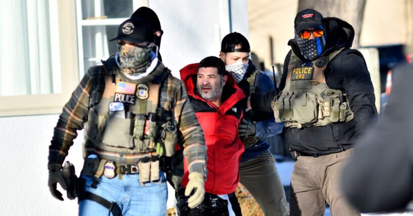 Federal immigration agents detain a man during an ICE and border patrol operation in St. Paul, Minnesota, on Jan. 27, 2026.