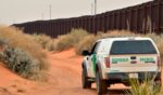 U.S. Border Patrol agent drives near the U.S.-Mexico border fence in Santa Teresa, New Mexico on April 6, 2016.