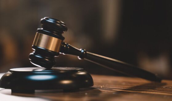 A gavel sits in an empty courtroom.