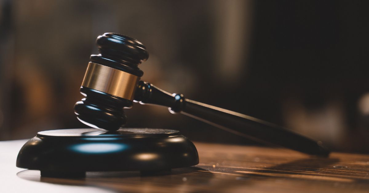 A gavel sits in an empty courtroom.