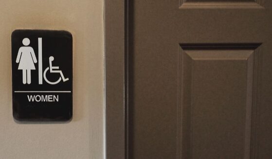 A private women's bathroom with symbol denoting it is to be used by women.