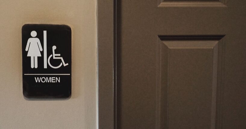 A private women's bathroom with symbol denoting it is to be used by women.