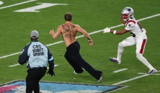 Wide receiver Kyle Williams helps security coral a streaker during Super Bowl LX at Levi's Stadium in Santa Clara, California, on Feb. 8, 2026.