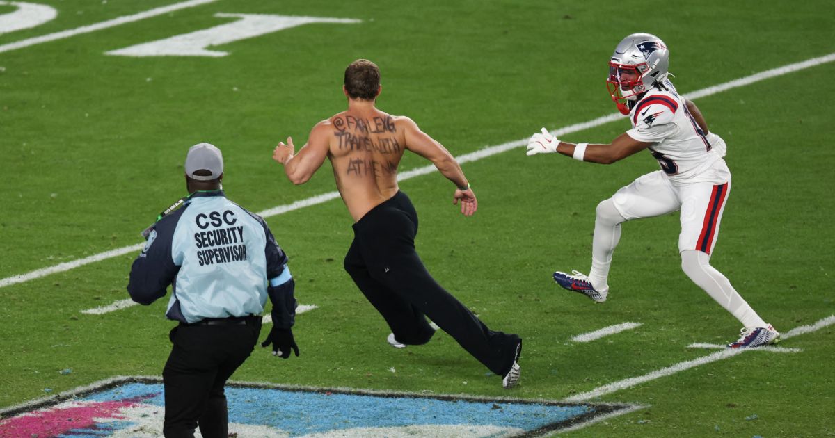 Wide receiver Kyle Williams helps security coral a streaker during Super Bowl LX at Levi's Stadium in Santa Clara, California, on Feb. 8, 2026.