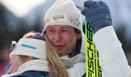 Bronze medalist Sturla Holm Laegreid of Team Norway embraces teammate Ingrid Landmark Tandrevold in Anthill-Anterselva, Italy, on Feb. 10, 2026.
