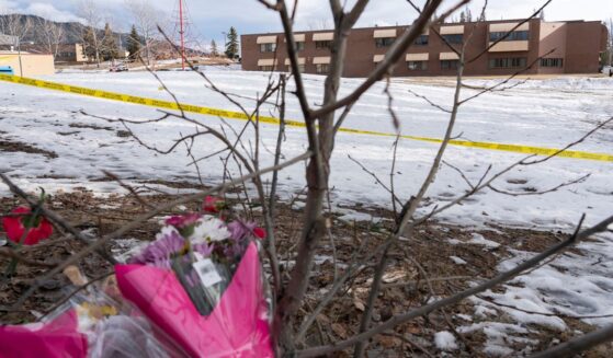 Flowers sit outside Tumbler Ridge Secondary School after a shooting took place leaving at least nine people dead in Tumbler Ridge, British Columbia, on Feb. 11, 2026.