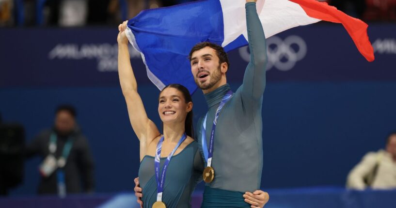 Gold medalists Laurence Fournier Beaudry and partner Guillaume Cizeron of Team France wave the French flag in Milan, Italy, on Feb. 11, 2026.