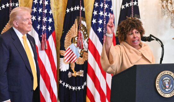 President Donald Trump looks on as Forlesia Cook speaks to reporters during a Black History Month event in the East Room of the White House in Washington, DC on Feb. 18, 2026.