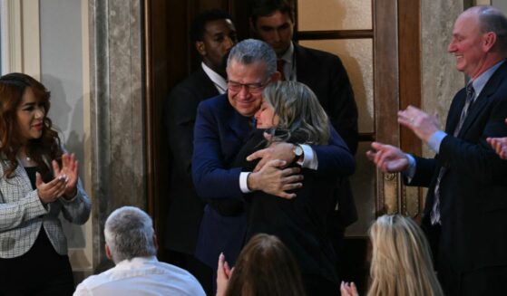Former Venezuelan presidential candidate and recently released prisoner Enrique Márquez embraces a family member as he is being recognized by President Donald Trump at the State of the Union address in the House Chamber of the US Capitol in Washington, DC on Feb. 24, 2026.