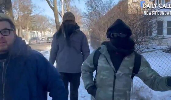 Masked activists assaulted a reporter who was asking questions about the illegal blockade they erected in a Minneapolis neighborhood.